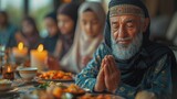 Fototapeta Na sufit - In this close-up, a Muslim man prays while eating with his family during Ramadan.