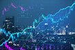 Creative glowing candlestick forex chart on blurry night city backdrop. Financial trade and market concept. Double exposure.