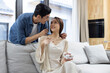 © Blue Jean Images - Happy young woman receiving gift from her husband