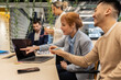 © Westend61 - Businesswoman discussing with colleague over laptop on desk at office