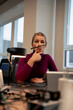 © Westend61 - Playful businesswoman balancing pen between nose and lips in office