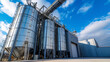 Modern agro-processing plant with grand granary elevators under blue sky