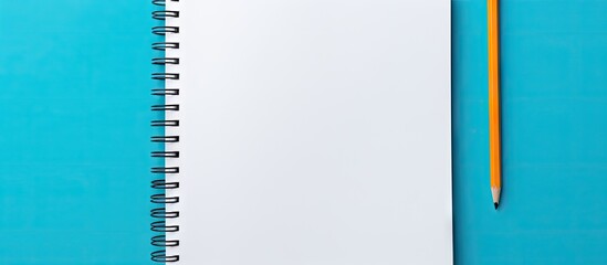 Poster - Artistic White Notebook and Pencil on Vibrant Blue Background