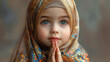 A Little sweet muslim girl wearing scarf praying