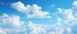 Fototapeta  - Aircraft Soaring Through Serene Blue Sky with Soft Fluffy Clouds on a Clear Day