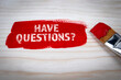 Have questions? Red color and text on wood texture background