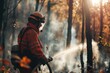 Experienced firefighter extinguishing a wildland fire by spraying water on a forest.