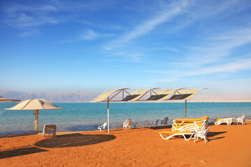 Wall Mural -  Dead Sea, the orange sand and beach chairs
