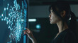A woman interacts with futuristic holographic technology in a dark room.