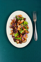 Wall Mural - Spicy mushroom salad with onions and walnuts.