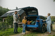 © Halfpoint - Family with electric car in front house with solar panels on roof. Solar, green energy and sustainable lifestyle of young family.