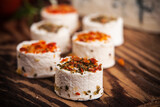 Fototapeta Miasto - Cheese rolls with various spices. Perfect as an apetizer