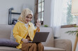 © SOMKID - Young asian islamic women with laptop computer in the living room.