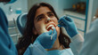Young woman is checked by a dentist if she has any dental problems and helps keep her mouth healthy in a dental clinic