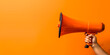 Orange megaphone in woman hand on a orange background, copy space, hiring, advertising, announce, banner concept