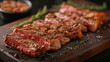 Beef Rib Eye steak slices on wooden board with herb