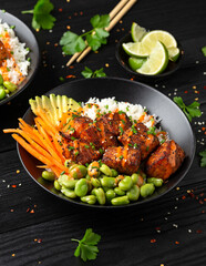 Wall Mural - Firecracker salmon poke bowl with edamame, avocado carrot and rice