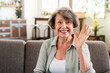 © InsideCreativeHouse - Cheerful caucasian senior woman having videocall online looking at camera and waving with hand. Old grandmother saying hello on webcam while calling