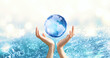 Water Day or World Oceans Day concept. Environmental conservation, save, protect clean planet Earth and ecology, sustainable lifestyle. Blue Globe ball in human hands on pure sea background.