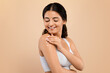 © Prostock-studio - Self Pampering Concept. Beautiful Indian Woman Applying Body Cream On Shoulder