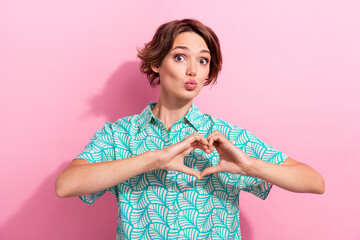 Wall Mural - Portrait of pretty nice person pouted lips kiss arms fingers demonstrate heart symbol isolated on pink color background