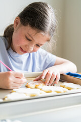 Wall Mural - Little Girl Spells 'Sorry' on Iced Sugar Cookies