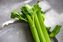 Fresh Organic Celery Sticks On A Textured Surface