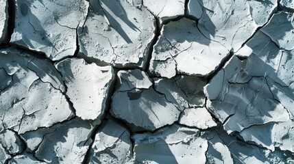 Poster - Cracked concrete texture background. Grey surface with cracks close up. A lot of pieces of splintered plaster. Abstract concept of split, dissent, disagreement, discord. Sunny day with shadows.