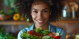 Fototapeta  - Black Woman Smiling and Holding a Bowl of Fresh Salad