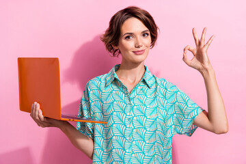 Poster - Photo of attractive person hold laptop demonstrate okey symbol approval isolated on pink color background