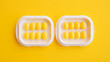 Blister packs of contraceptive pills on yellow background