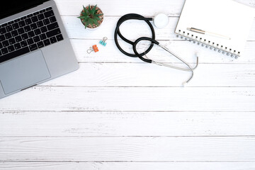 Wall Mural - Flat lay, medical technology and healthy concept on modern white table desk background with stethoscope and laptop computer, blank notepad, supplies, Top view with copy space