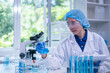 © Supapich - Closeup female woman scientist's hand holding blue liquid chemical chemistry test tube flask working in analyze science laboratory research experiment
