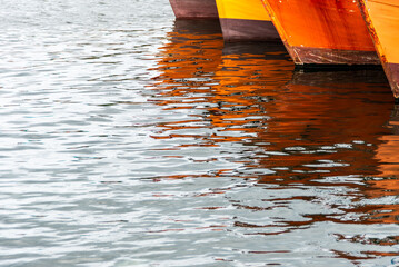 Reflection of the prows of fishing boats in the port of Mar del Plata, Argentina