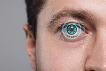 Sticker - Vision test. Man and digital scheme focused on his eye against grey background, closeup