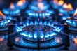 Gas burning from a kitchen gas stove. blue gas flame on hob. closeup selective focus natural 
