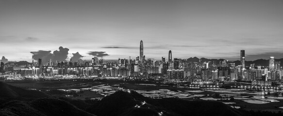 Wall Mural - Panorama of skyline of Shenzhen city, China at sunset. Viewed from Hong Kong border