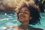 Fototapeta Londyn - happy beautiful young african woman relaxing in hot spring pool in the morning