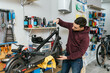 © Jordi Mora - Bike mechanic adjusting an electric scooter.