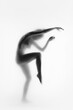 Inner peace and self-care. Blurred silhouette of naked woman posing in dynamic pose against light background. Black and white. Concept of body aesthetics, femininity, beauty, health, art