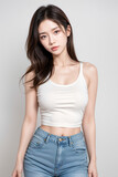 Fototapeta Sport - Gorgeous Young Female Model - Fashion or Cosmetics Model - White Top and Blue Jeans - Flawless Skin and Fine features - Beautiful Smooth Hair