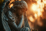 Fototapeta  - Sad angel statue at sunset, funeral services, grief, sorrow and condolences card Sad or obituary notice