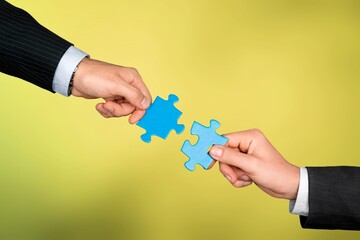 Wall Mural - People hands connecting colored puzzles.