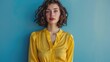 © qntn - Confident businesswoman in vibrant yellow blouse posing with assurance against a serene blue background, exemplifying professional poise and determination - AI generated