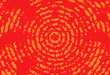 Abstract concentric orange wave on a red background. Grunge circles made of dashed lines. Hypnotic background.