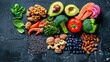 Assorted healthy food items on a dark background - A vibrant selection of healthful foods including fruits, vegetables, and nuts artfully arranged on a dark textured surface