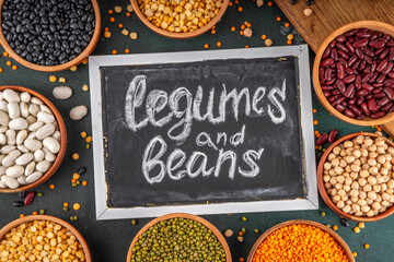 Wall Mural - Various dried  beans, lentils, mung, chickpea, pea  assortment in wooden bowls. Legumes on white table top view. Vegan protein sources food, copy space