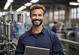 Fototapeta  - Portrait of smiling caucasian technologist expert with tablet computer standing by automated machine for water production in bottling factory.
