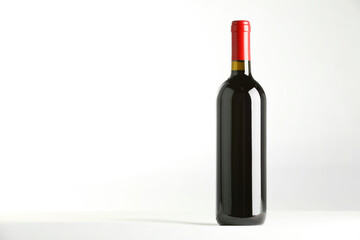 Sticker - Bottle of expensive red wine on white background. Space for text