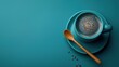 Overhead Shot of Coffee Cup, Spoon, and Beans on Cyan Background: Cafe Branding Resource 